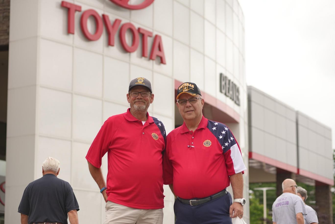 Veterans in patriotic shirts in front of Beaver Toyota of Cumming